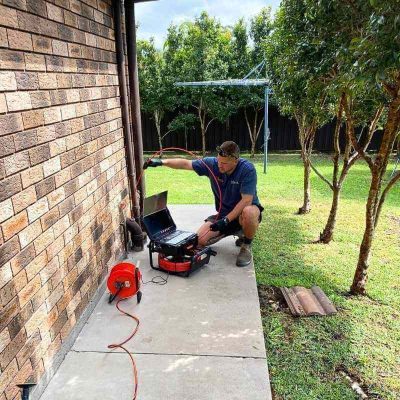 A plumber using a Razorback Drain Camera