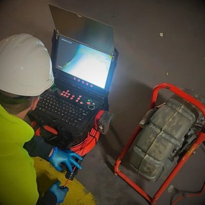 Drain Camera Cable Being Uncoiled by a Plumber